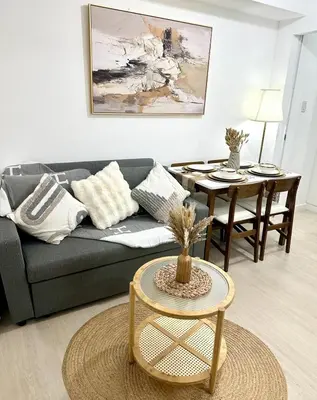 a living room with a couch and a table at Azure Luxury Suite in Manila