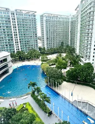 a large pool in the middle of a city with tall buildings at Azure Luxury Suite in Manila