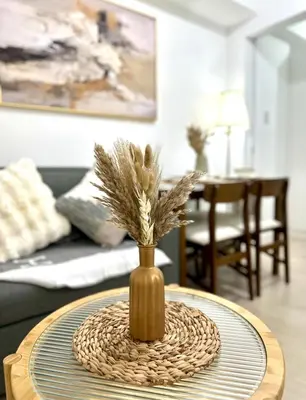 a vase with feathers in it sitting on a table at Azure Luxury Suite in Manila