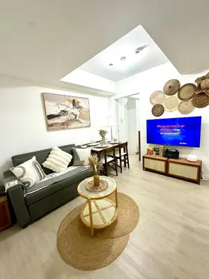a living room with a couch and a table at Azure Luxury Suite in Manila