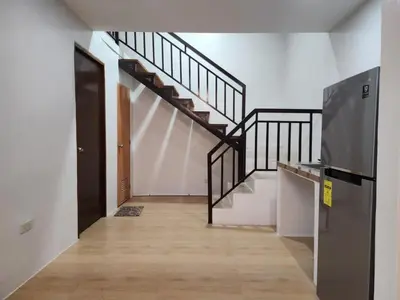 an empty hallway with a staircase and a door at Green Glory Staycation in Amadeo in Cavite