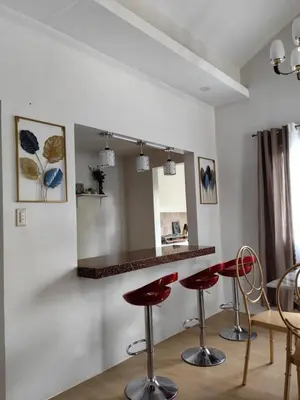 a bar with red stools in a room at Green Glory Staycation in Amadeo in Cavite