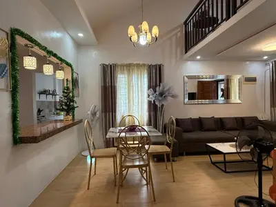 a living room with a table and a couch at Green Glory Staycation in Amadeo in Cavite
