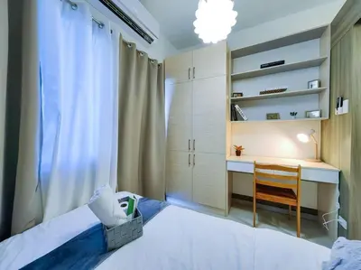 a bedroom with a desk and a bed with a chair at 1BR Condotel with Balcony at FAME Residences #FM18 in Manila
