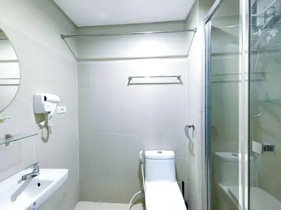a bathroom with a shower and a toilet and a sink at 1BR Condotel with Balcony at FAME Residences #FM18 in Manila