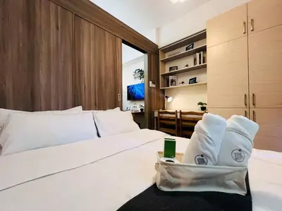 a bedroom with a white bed with towels on it at 1BR Condotel with Balcony at FAME Residences #FM19 in Manila