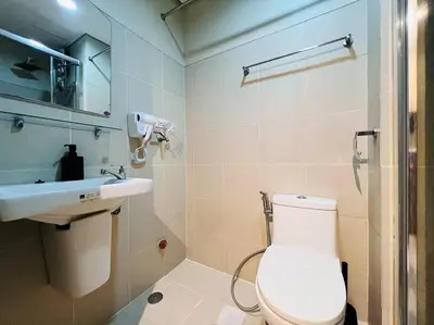 a bathroom with a toilet and a sink at 1BR Condotel with Balcony at FAME Residences #FM19 in Manila