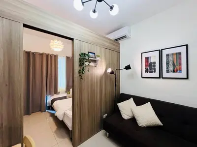 a living room with a couch and a bedroom at 1BR Condotel with Balcony at FAME Residences #FM19 in Manila