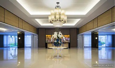 a lobby with a table with a vase of flowers at 1 Bedroom Condo Unit Near MOA with Netflix and WIFI in Manila
