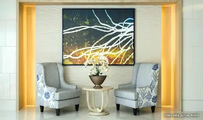 two chairs and a table in a room with a painting at 1 Bedroom Condo Unit Near MOA with Netflix and WIFI in Manila