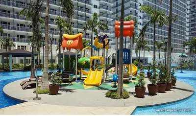 a playground in a resort with a slide at 1 Bedroom Condo Unit Near MOA with Netflix and WIFI in Manila