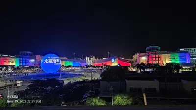a city lit up at night with colorful lights at 1 Bedroom Condo Unit Near MOA with Netflix and WIFI in Manila