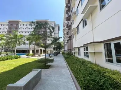 a walkway in front of a building with a park at Jasrich Suite Behind SM trece martires HOPE RESIDENCES SMDC in Cavite