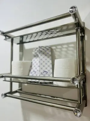 a metal shelf with toilet paper and towels at Jasrich Suite Behind SM trece martires HOPE RESIDENCES SMDC in Cavite
