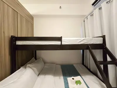a couple of bunk beds in a room at 1BR Condotel with Balcony at FAME Residences #FM40 in Manila