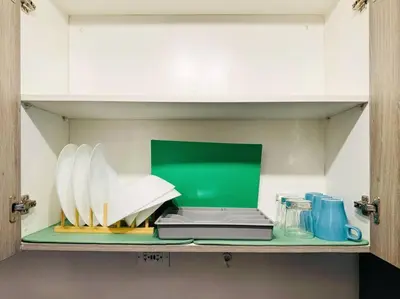 a shelf with plates and a laptop on it at 1BR Condotel with Balcony at FAME Residences #FM41 in Manila