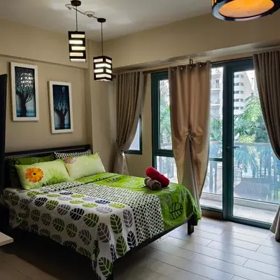 a bedroom with a bed with a teddy bear on it at LDN Secret Crib - Two Palm Tree Newport City in Manila