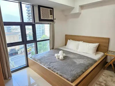 a bedroom with a bed with two teddy bears on it at Affordable Condo Suite with 150mbps WIFI in Manila