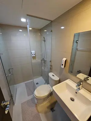 a bathroom with a shower and a toilet and a sink at Affordable Condo Suite with 150mbps WIFI in Manila