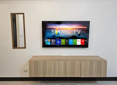 a flat screen tv sitting on top of a wall at Affordable Condo Suite with 150mbps WIFI in Manila