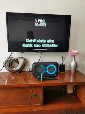 a tv sitting on top of a wooden table at Mall of Asia Pasay Shore 3 residences tower 2 in Manila