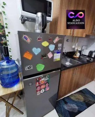 a refrigerator with magnets on it in a kitchen at Mall of Asia Pasay Shore 3 residences tower 2 in Manila