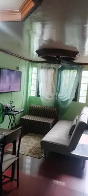 a living room with a couch and a tv at 3J's Place in General Trias