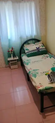a small bed in a room with a curtain at 3J's Place in General Trias