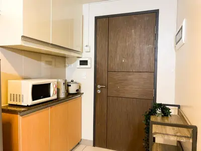 a kitchen with a microwave and a door at BGC Staycation: 1BR Condo Uptown Area #ournw12d in Manila