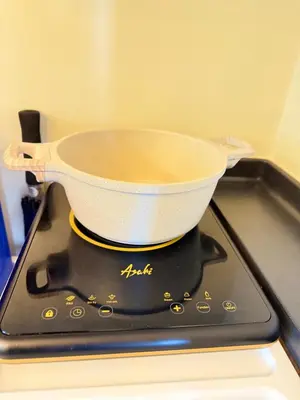 a pan sitting on top of a stove at Meteor Suites in Manila
