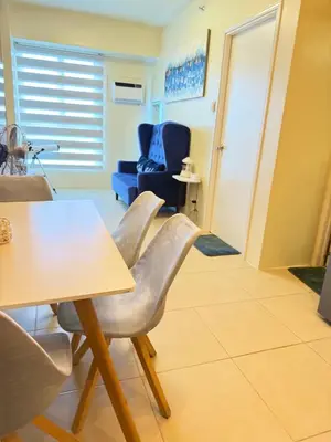 a dining room with a table and a chair at Meteor Suites in Manila