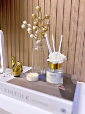 a table with a vase of flowers and a bottle of perfume at The 3rd Staycation Near MOA, Airport, with FREE WIFI, Netflix in Manila