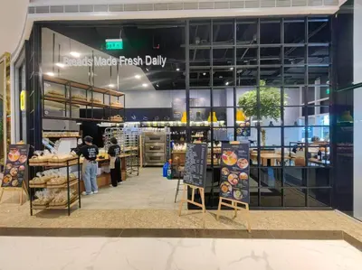 a bakery with a person standing in front of a store at 1BR Condotel with Balcony at FAME Residences #FM42 in Manila