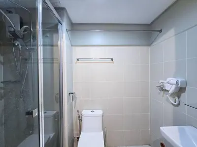 a bathroom with a shower and a toilet and a sink at 1BR Condotel with Balcony at FAME Residences #FM43 in Manila