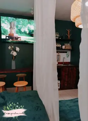 a bedroom with a bed and a green wall at El Nissi Staycation, THE GARDEN CABIN, Enchanted Kingdom in Santa Rosa