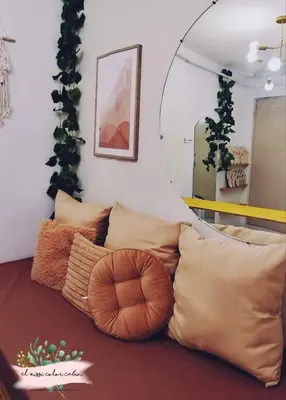 a bunch of pillows on a couch in a room at El Nissi Staycation, THE COLOR CABIN, Enchanted Kingdom in Santa Rosa