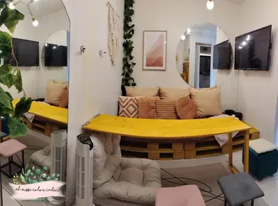 a room with a couch and a mirror at El Nissi Staycation, THE COLOR CABIN, Enchanted Kingdom in Santa Rosa