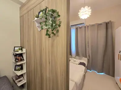 a room with a curtain and a bed in a room at 1BR Condotel with Balcony at FAME Residences #FM44 in Manila