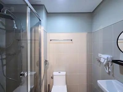 a bathroom with a shower and a toilet and a sink at 1BR Condotel with Balcony at FAME Residences #FM45 in Manila