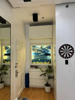 a room with a dart board on the wall and a window at Minimalist Luxury Spacious 1 Bedroom in Burgos Circle in Manila