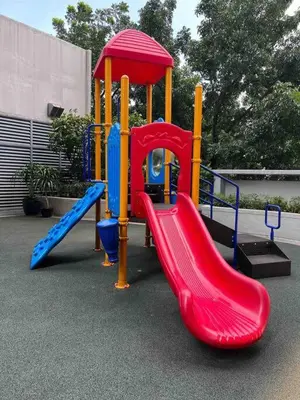 a playground with a red and blue slide at Studio at viceroy 4 Taguig in Manila