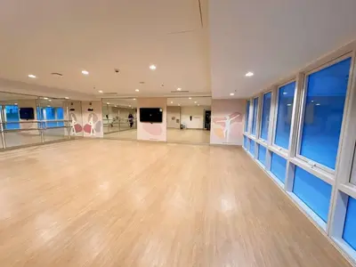 a large empty room with wooden floors and windows at Pet & WFH Friendly Home Near BGC in Manila