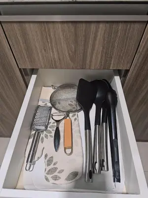 a drawer full of kitchen utensils in a cabinet at Pet & WFH Friendly Home Near BGC in Manila