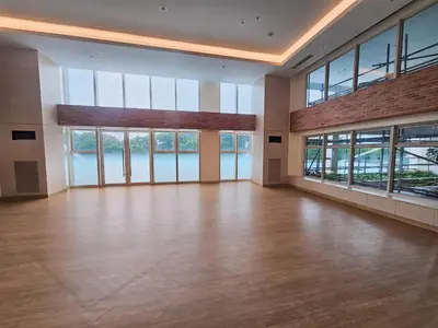 an empty room with wood floors and large windows at Pet & WFH Friendly Home Near BGC in Manila