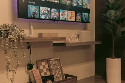 a living room with a tv on a wall at The Skyline Oasis Makati in Manila