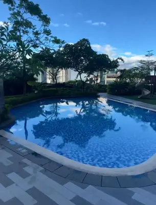 a large swimming pool with blue water at The Skyline Oasis Makati in Manila