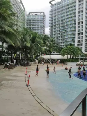 a group of people playing in a swimming pool at Azure - Stellar Property in Manila