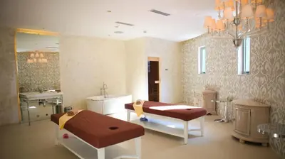 a bathroom with a sink and a bed in a room at High-end 2BR Condo Boracay Tower - Azure Residences near Manila Airport in Manila