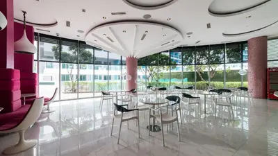 a dining room with tables and chairs and large windows at High-end 2BR Condo Boracay Tower - Azure Residences near Manila Airport in Manila
