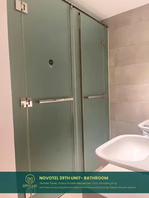 a shower with a glass door in a bathroom at Novotel Twin Bed at Mandaluyong Near Makati FREE pool in Manila